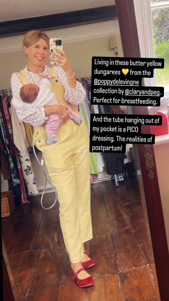 Woman holding newborn baby in yellow dungarees.