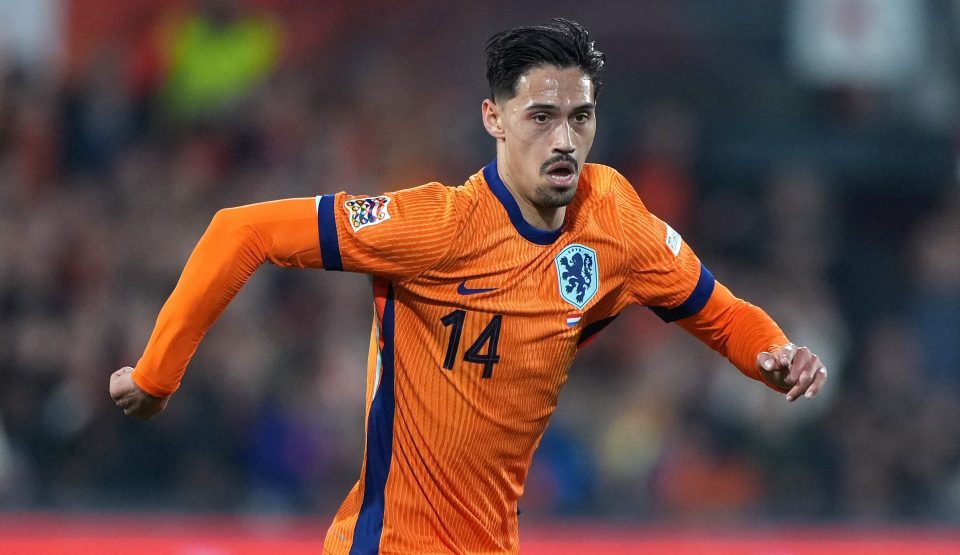 Tijjani Reijnders #14 of the Netherlands dribbling the ball during a soccer match.
