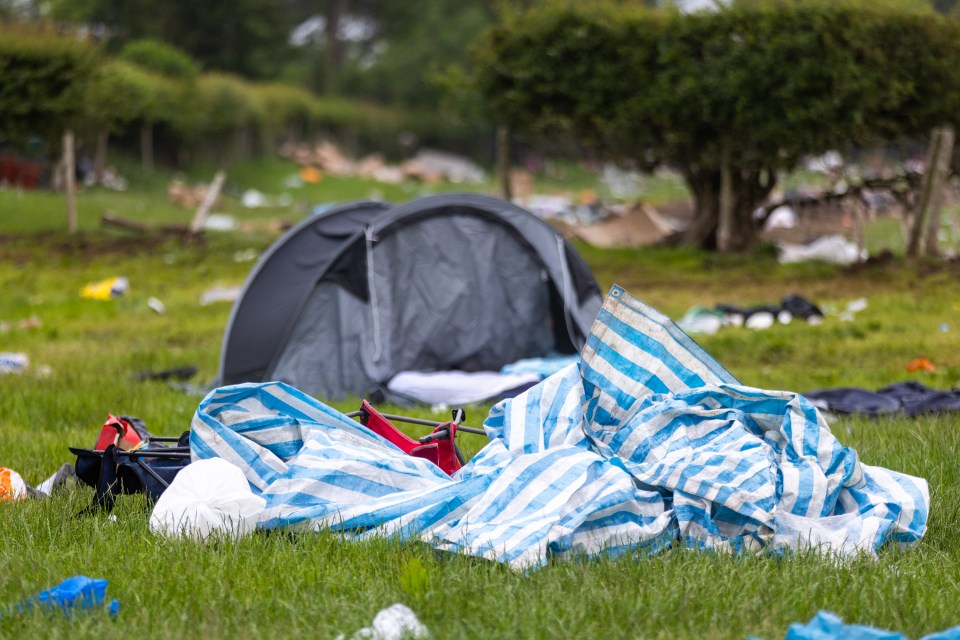 Rubbish and discarded camping equipment left on a grassy field after the Appleby Horse Fair.