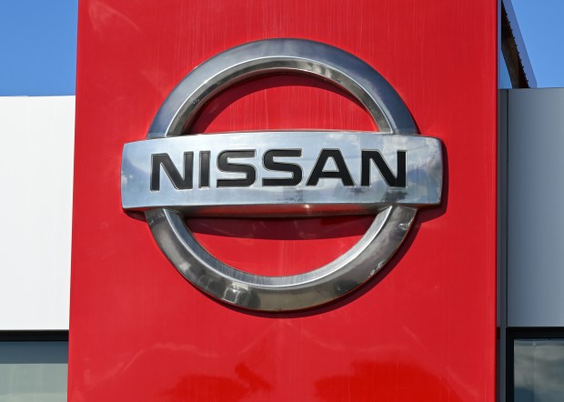 Nissan logo on a red wall.