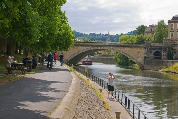 River Avon in Gloucestershire, England, with a bridge and people enjoying the riverside path.