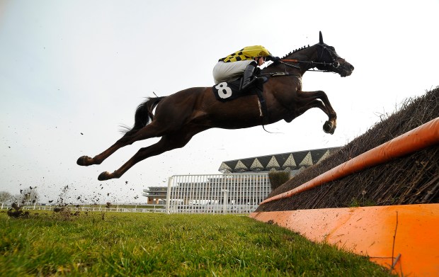 ASCOT, ENGLAND - APRIL 07: James Davies riding Escort'Men clear a fence in The BMW Ascot Novices' Handicap Steeple Chase at Ascot racecourse on April 07, 2013 in Ascot, England. (Photo by Alan Crowhurst/Getty Images for Ascot Racecourse)
