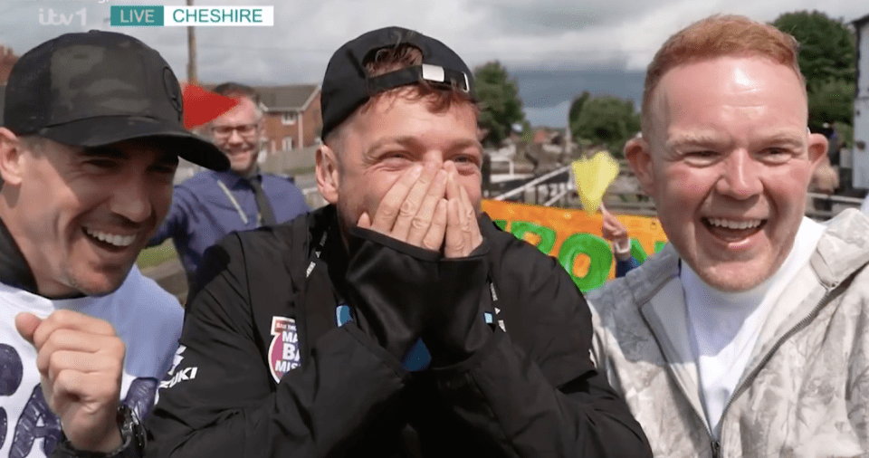 Screenshot of three men laughing outdoors.