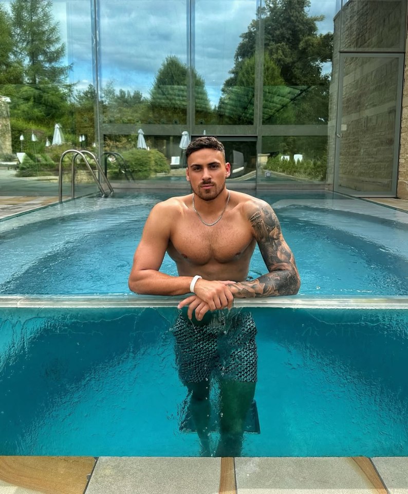 Man with tattoos in a swimming pool.