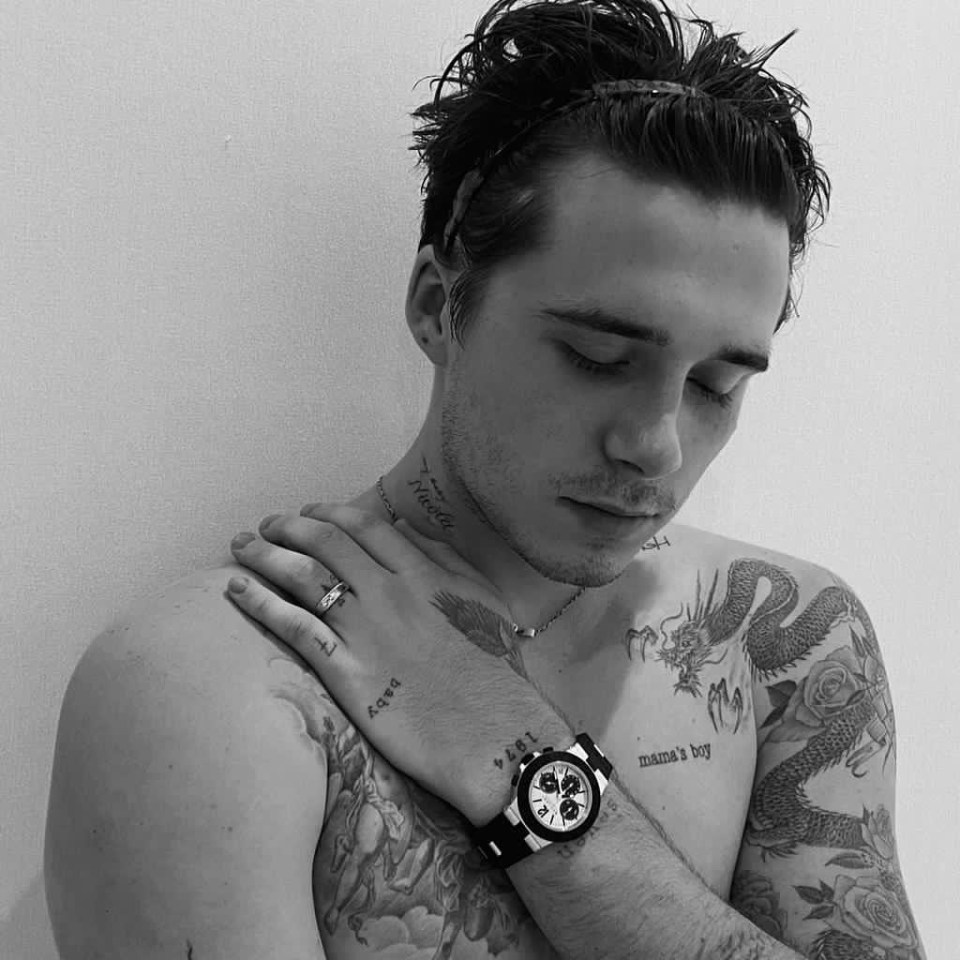 Black and white photo of Brooklyn Beckham with Nicola's name tattooed on his neck.