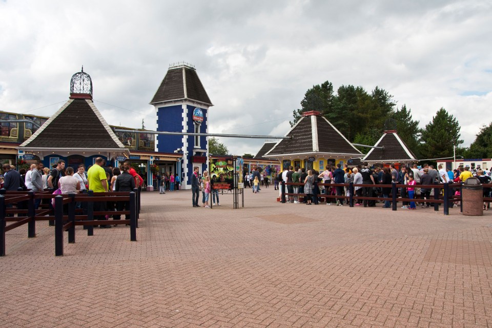 Entrance to Alton Towers theme park with people queuing.