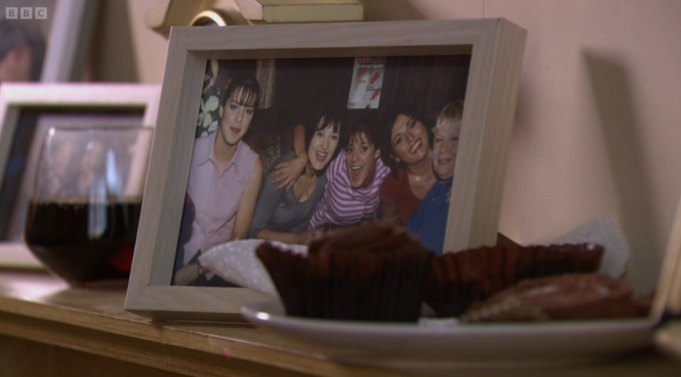 Framed photo of a group of women and a young boy, with muffins in the foreground.