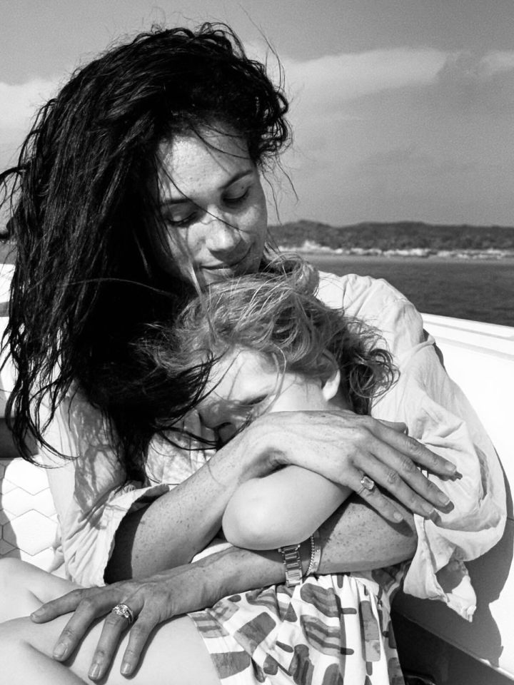 Black and white photo of a woman hugging a young child.
