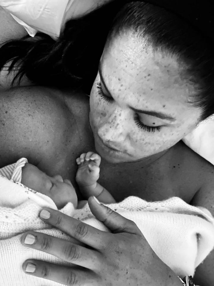 Black and white photo of a mother holding her newborn baby.