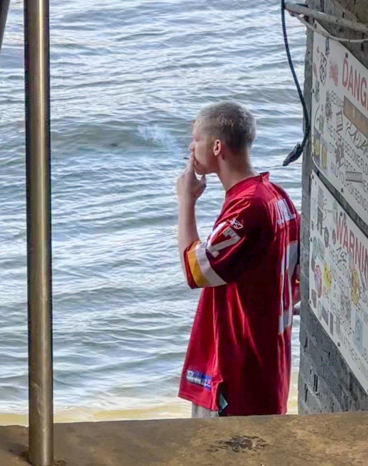 Freddy Brazier smoking near the Thames River.