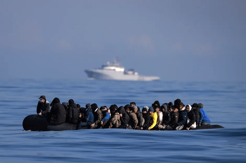 Migrants in a small boat at sea.