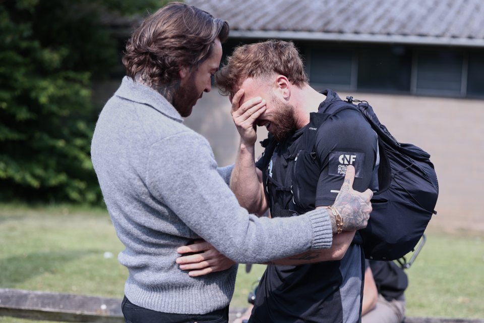 Sam Thompson comforts Pete Wicks during a fundraising challenge.